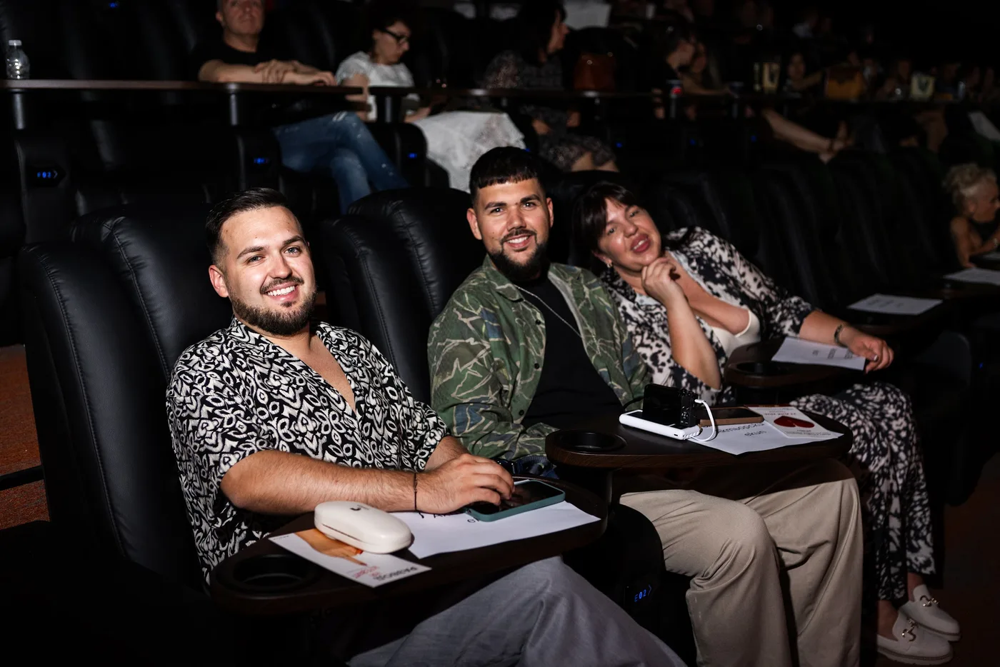 Smiles in the cinema auditorium — Divorce on Credit gala premiere, July 23, 2026.